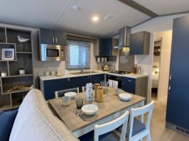 interior photo of the dining area and kitchen in a Regal Retreat 2 bedroom Static Holiday Caravan