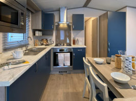 interior photo of the dining area and kitchen in a Regal Retreat 2 bedroom Static Holiday Caravan